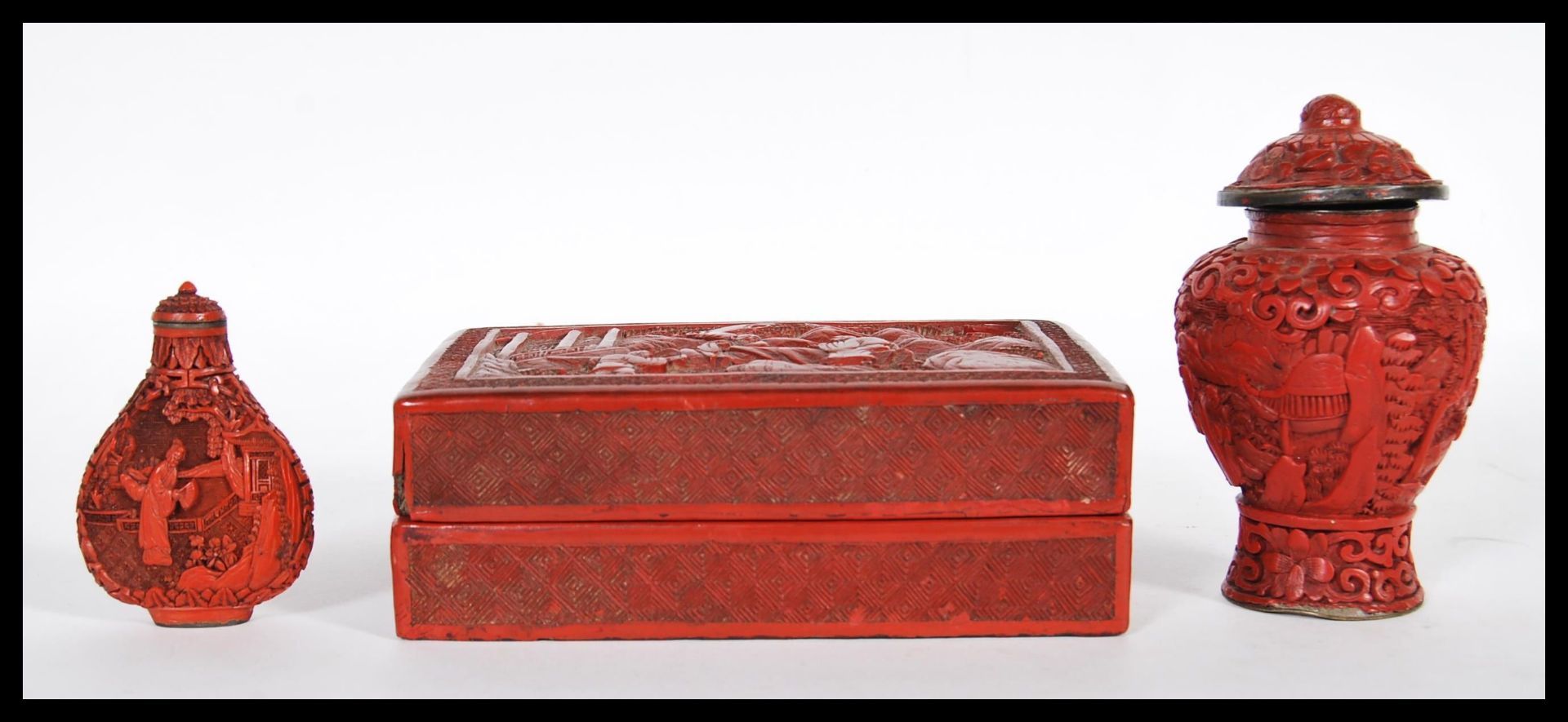 Three Chinese red cinnabar lacquer items to include, snuff bottle and stopper decorated with