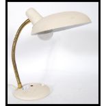 A vintage mid 20th Century gooseneck desk lamp, set to a circular base with inset switch gilt