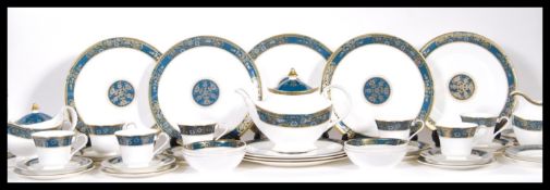 A tea set and part dinner service by Royal Doulton in the Carlyle pattern consisting of, seven cups,