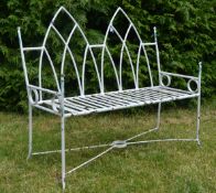 An early 20th Century Gothic revival cast iron garden bench, the bench having a twin arch gothic