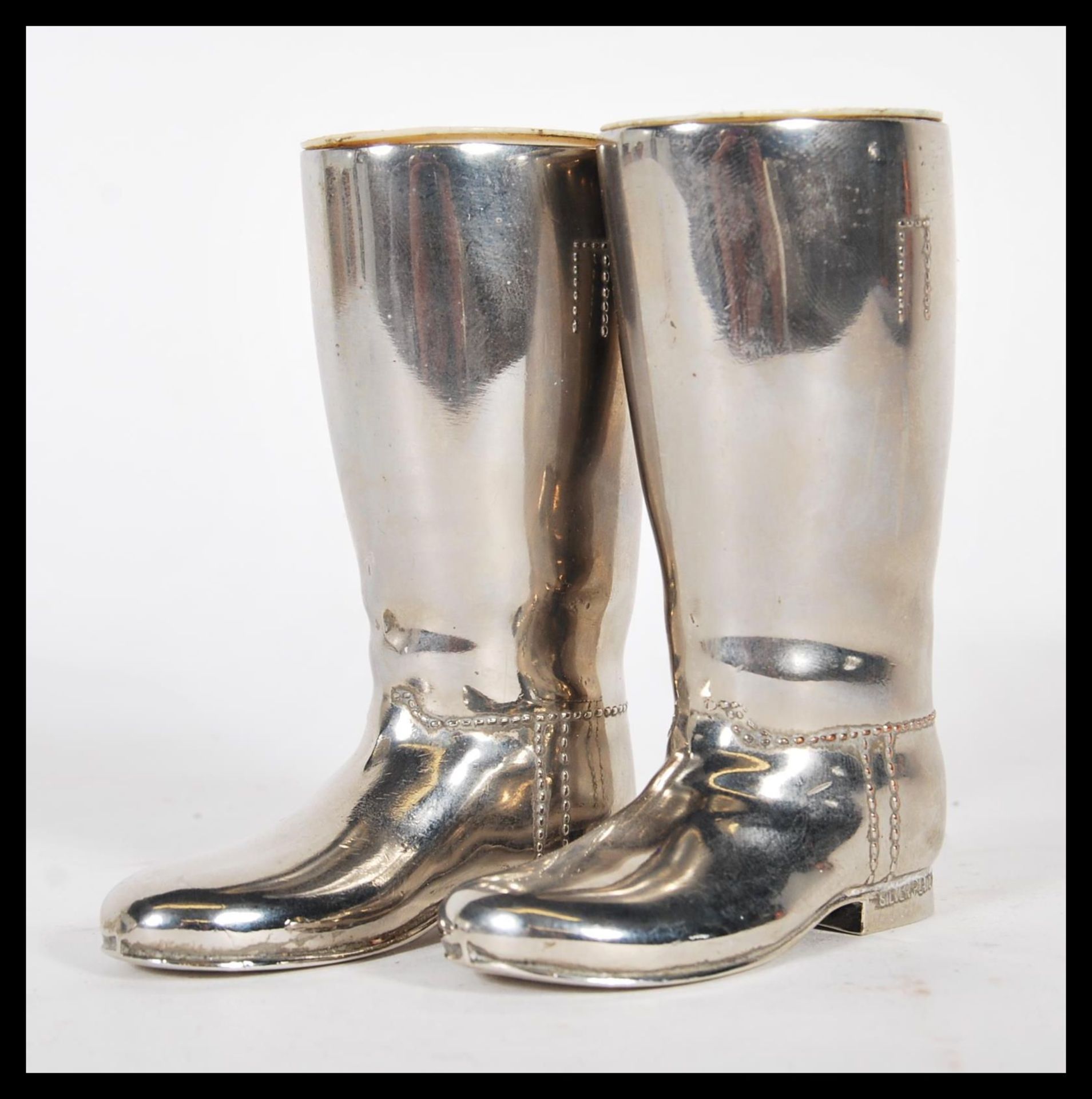 A pair of 20th century silver plated drinks measures for spirits in the form of horde riding