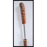 A 20th Century walking sword stick cane having bamboo root ball top and brass band. The handle pulls