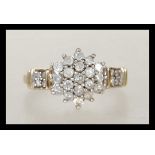 A hallmarked 9ct gold ladies cluster ring set with a central cluster of white stones and white