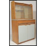 A vintage mid 20th Century kitchen cabinet cupboard in two parts, the lower section having a