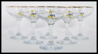 A set of six vintage retro 20th Century Babycham glasses raised on circular bases with gilt rim