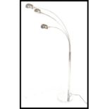 A vintage style atomic three point chrome floor lamp, circular base with chrome tubular upright