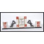 A 1930's Art Deco French 3 piece marble clock garniture set. The square shaped clock with inset