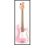 A four string electric bass guitar by swift having a hot pink sprayed body with white scratch guard.