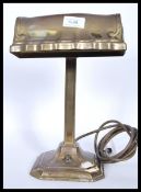 A good 20th century brass bankers desk lamp raised on a terraced square base and brass shade atop.