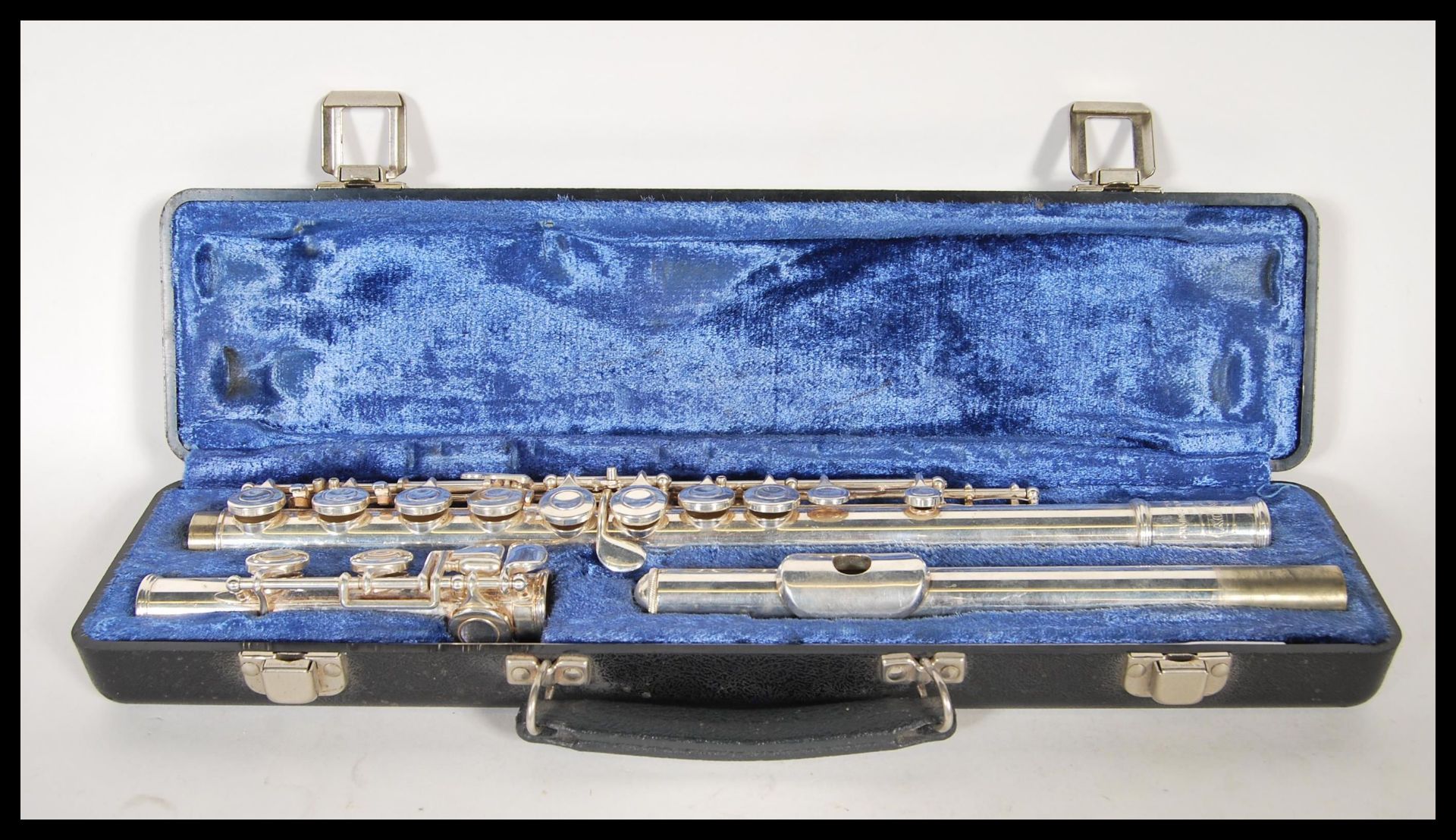 A Bundy Selmar Company nickel plated three part flute within a fitted velvet lined carry case