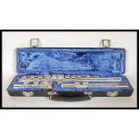 A Bundy Selmar Company nickel plated three part flute within a fitted velvet lined carry case