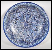 A 20th Century Persian Islamic pottery centrepiece charger plate having having painted blue