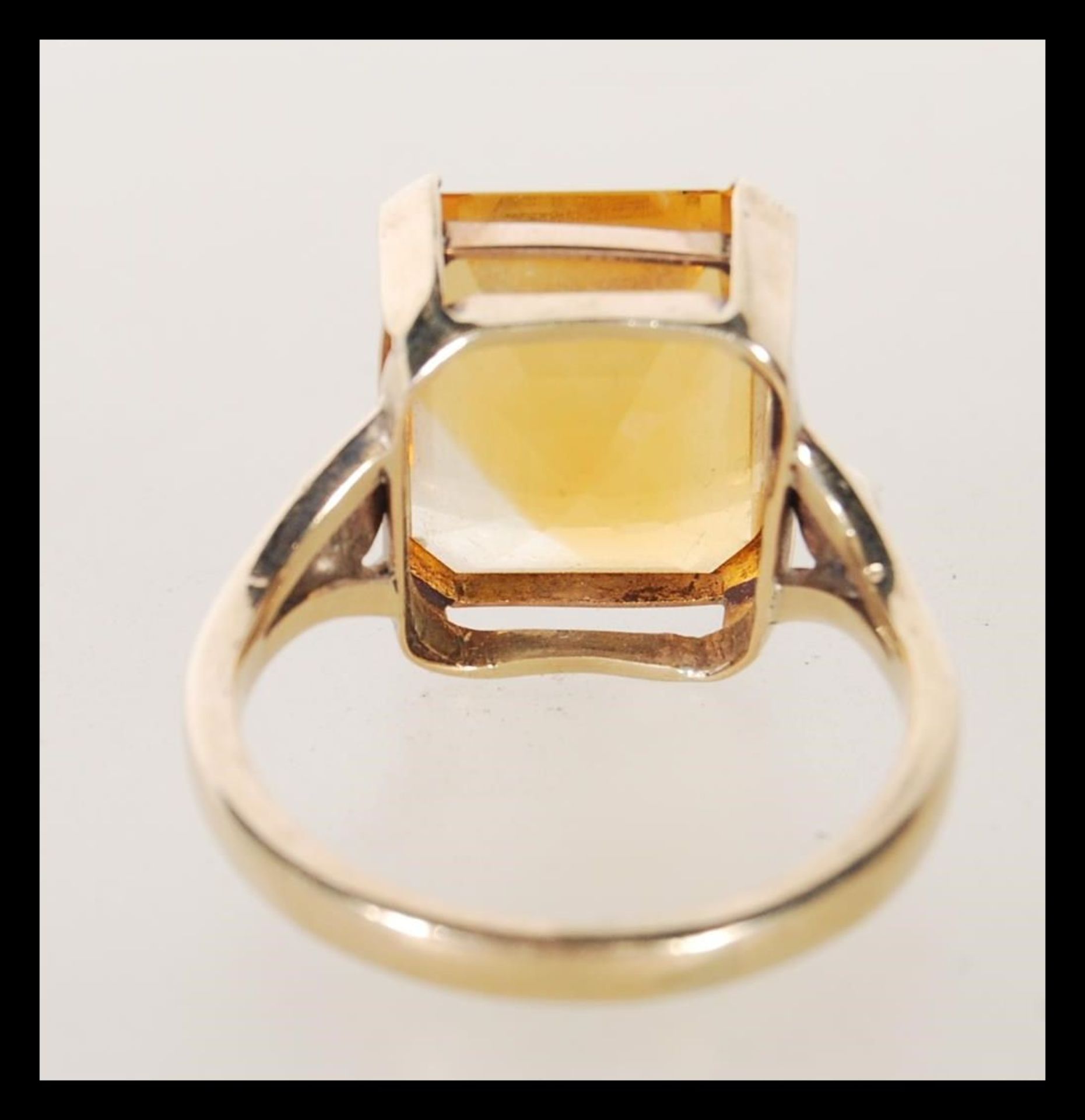A 9ct gold dress ring, prong set with a square cut orange stone on a split shank mount. Unmarked but - Bild 3 aus 4