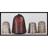 A group of three silver hallmarked thimbles to include a Charles Horner thimble within a fitted Hogg