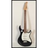 A 20th Century Cort G Series six string electric guitar, serial number 020906190, black finish to