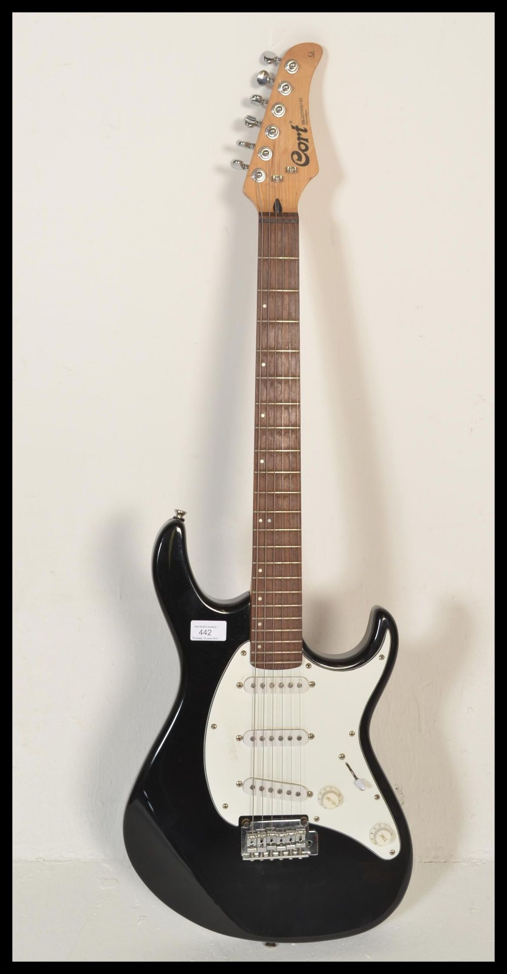 A 20th Century Cort G Series six string electric guitar, serial number 020906190, black finish to