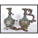 A pair of 19th Century Qing dynasty Chinese brass cloisonne wine jugs having enamelled floral sprays