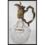 A early 20th Century silver plated claret jug, having cut crystal glass bulbous body and tapering