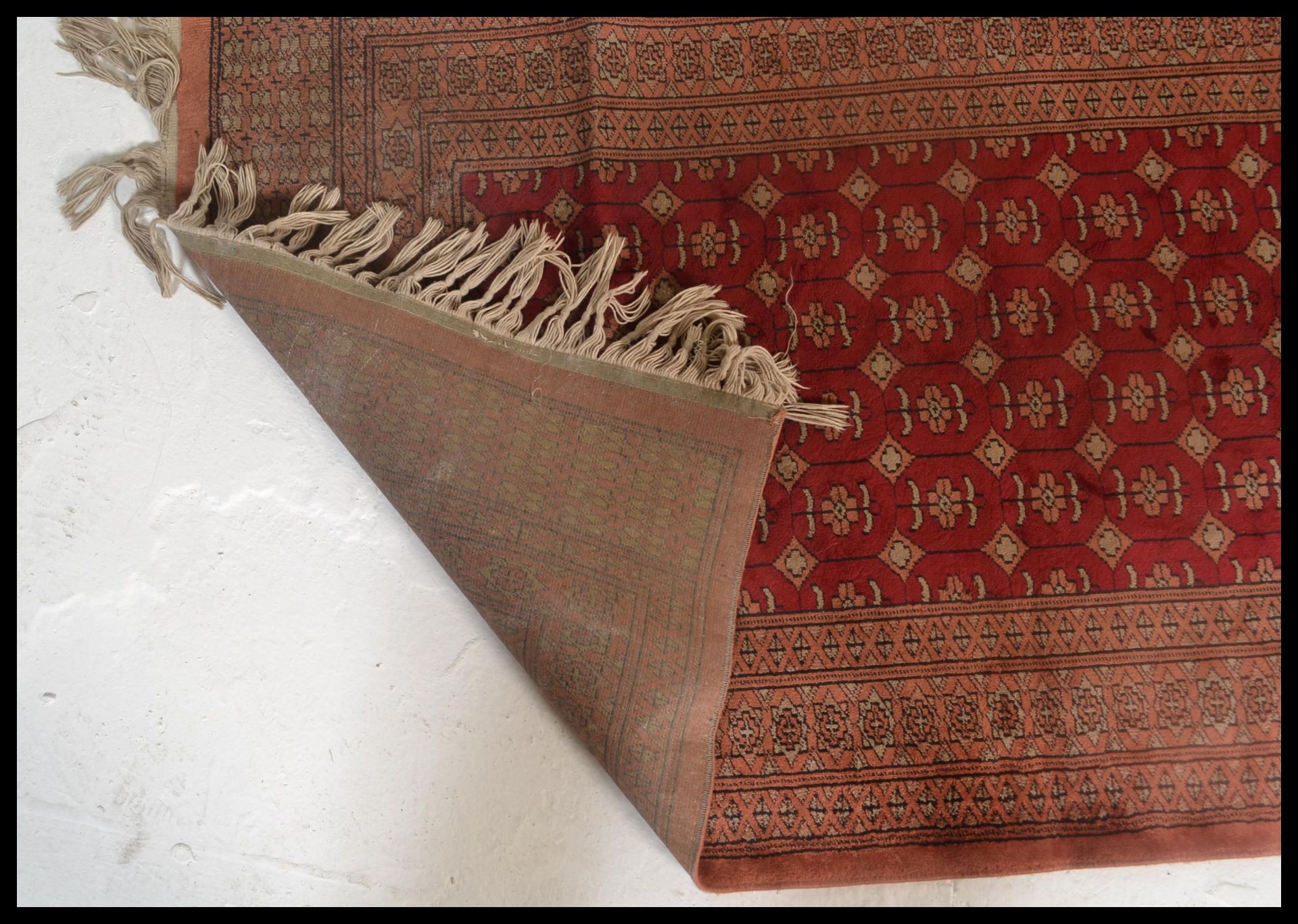 A vintage woolen Persian / Islamic floor rug runner set  on red ground,central panel with - Image 5 of 5
