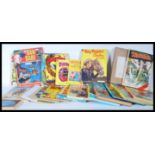 A collection of 20th Century books, annuals, comics to include, Biggles, Rupert, Dan Dare, Tarzan,