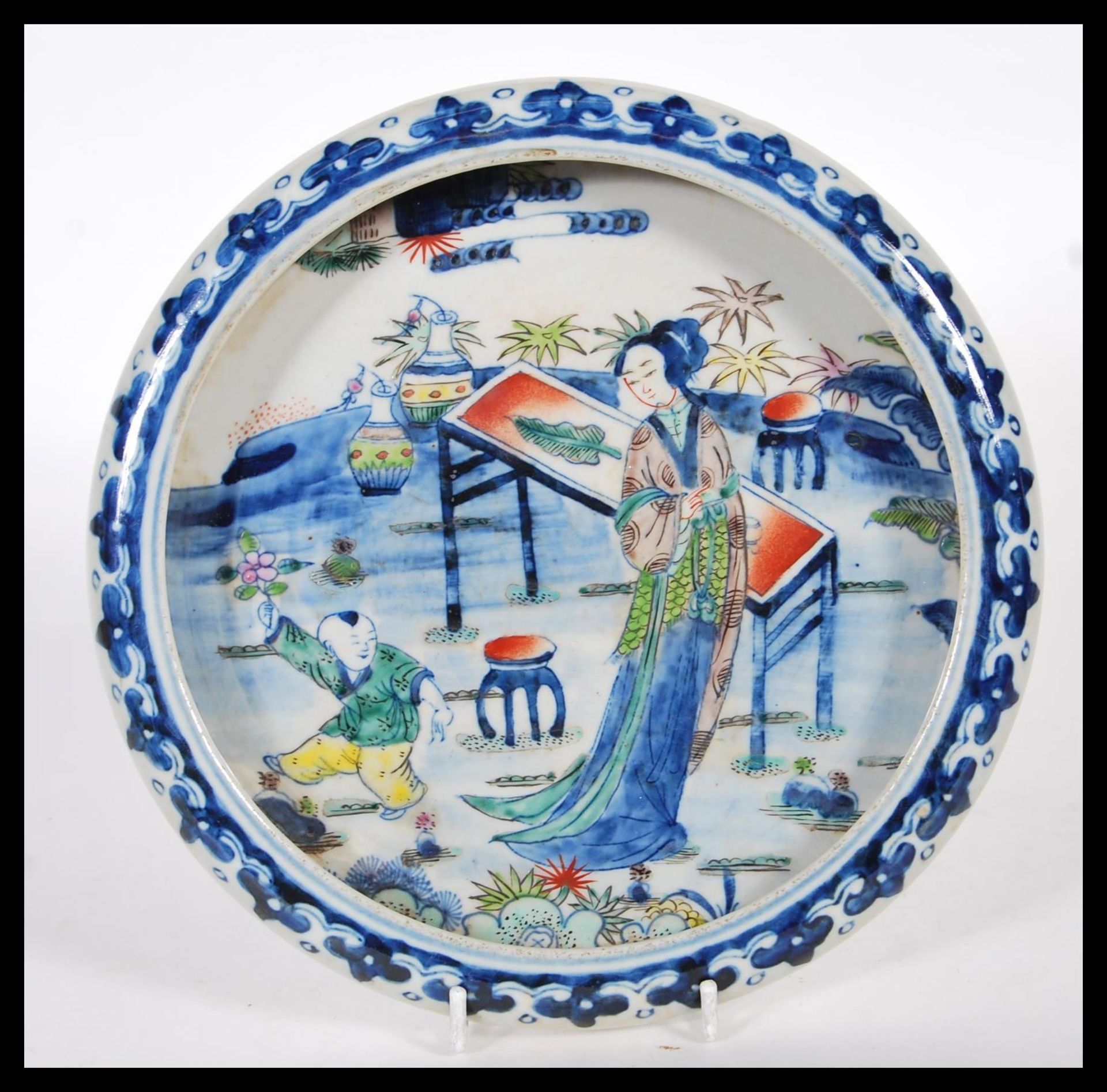 A early 20th Century dish / bowl having raised rim finished with blue decoration, the center of