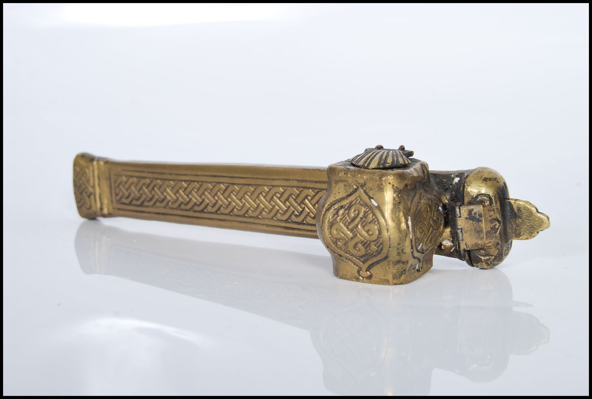 A 20th Century brass Persian Qalandan scribe inkwell case, having hinged lids and engraved
