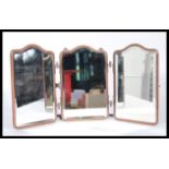 An early 20th Century triptych mirror constructed from three bevelled glass panels mounted in a