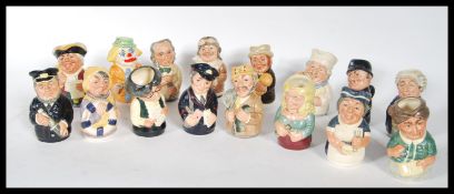 A collection of sixteen Royal Doulton miniature character jugs from The Doultonville Collection.