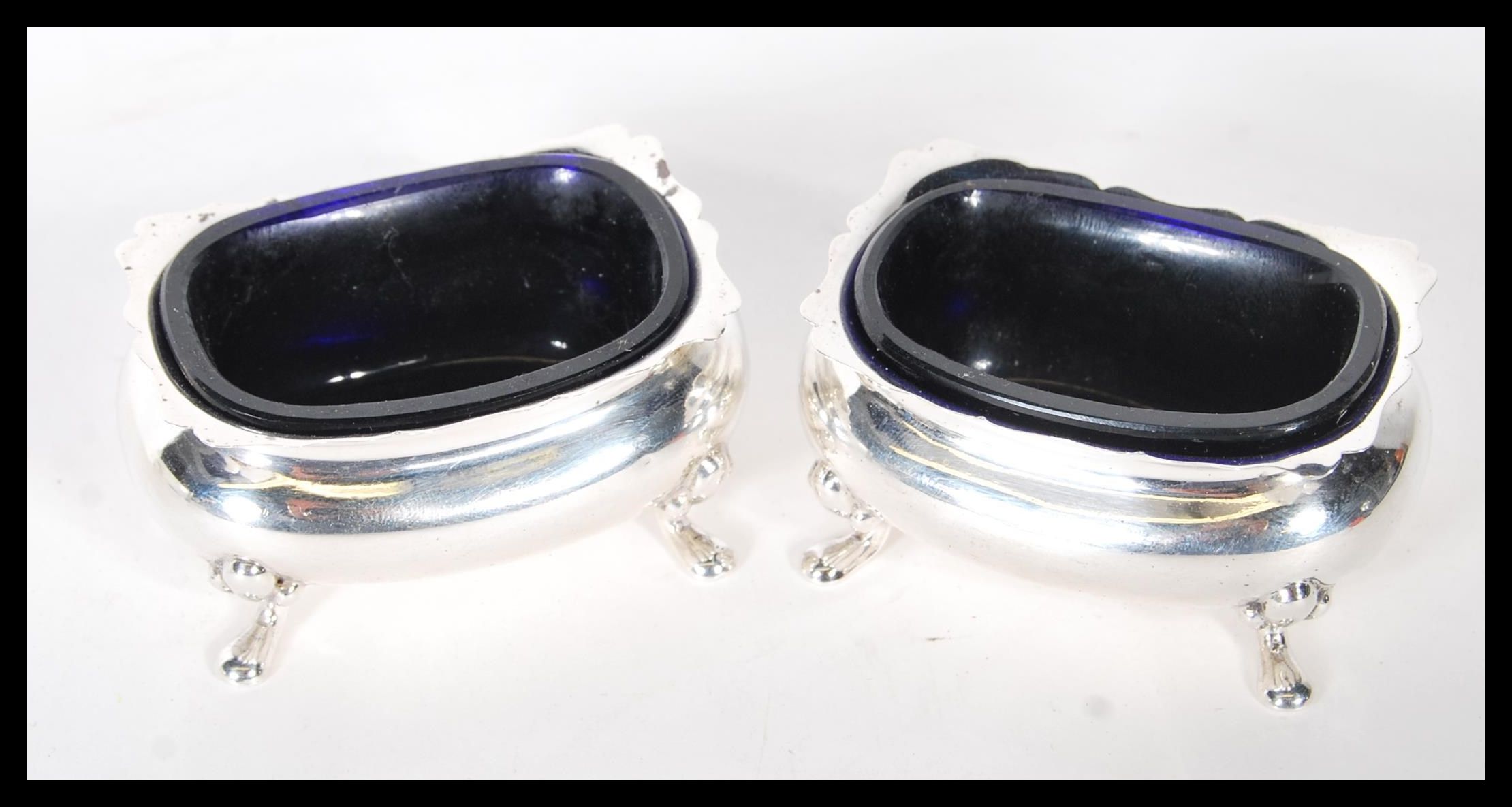 A pair of silver hallmarked Brook & Sons of Edinburgh blue glass lined table salts, all raised on - Image 2 of 5