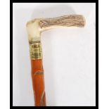 A 20th Century walking sword stick cane having bone crook handle with with brass banding. Handle