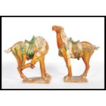 A pair of vintage 20th Century reproduction Chinese Tang dynasty ceramic War Horses. Having majolica