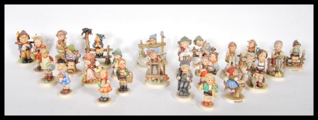 A collection of vintage German mid to late 20th Century Goebel Hummel ceramic figurines of children,