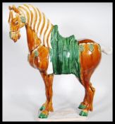 A large 20th Century Chinese Tang dynasty style war horse. Having majolica style drip ware glaze.