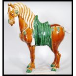 A large 20th Century Chinese Tang dynasty style war horse. Having majolica style drip ware glaze.