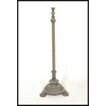 An early 20th Century brass and copper standard lamp, having flared top on corinthian style column