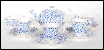 A late 19th Century Copeland Spode coffee set having blue floral design on white ground and gilt