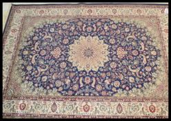 A large Persian floor carpet Keshan rug having a blue ground with geometric borders and