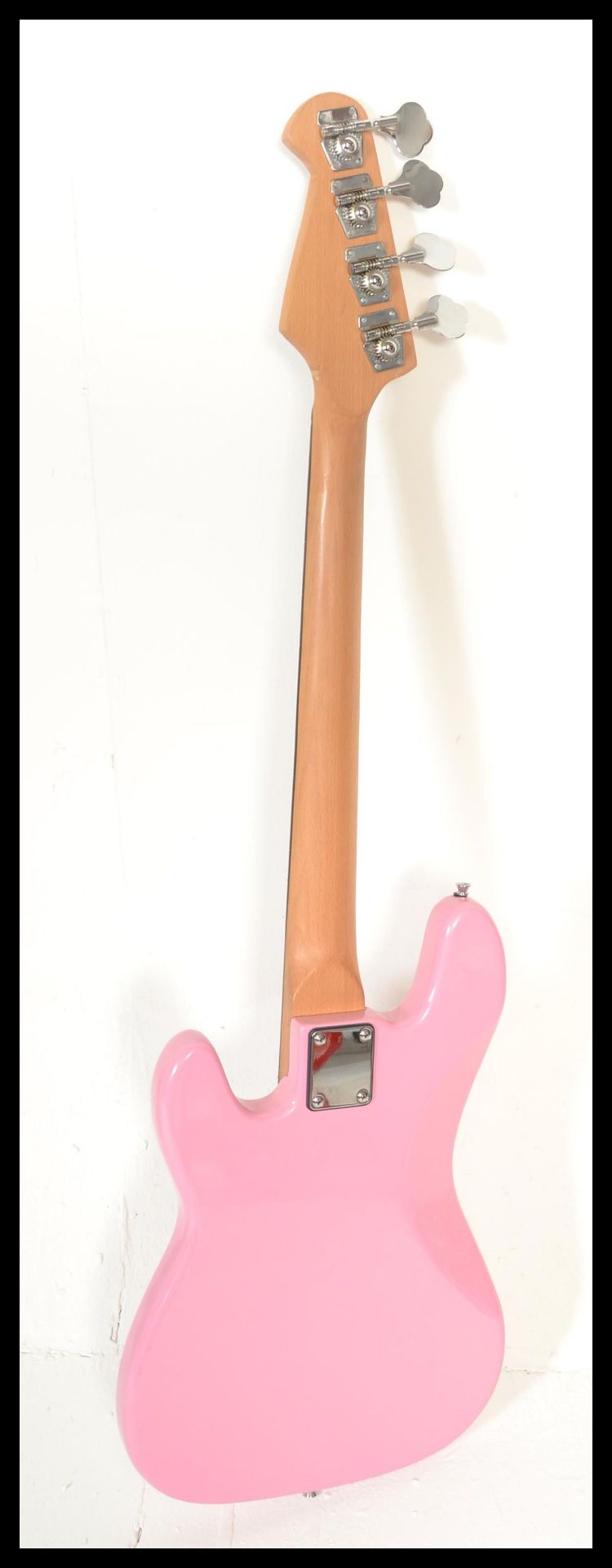 A four string electric bass guitar by swift having a hot pink sprayed body with white scratch guard. - Bild 4 aus 4