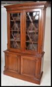 A Victorian mahogany library bookcase cabinet having a  moulded cornice set over two astragal glazed