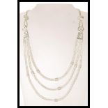 A 20th Century silver ethnic style necklace having three graduating snake chains with floral