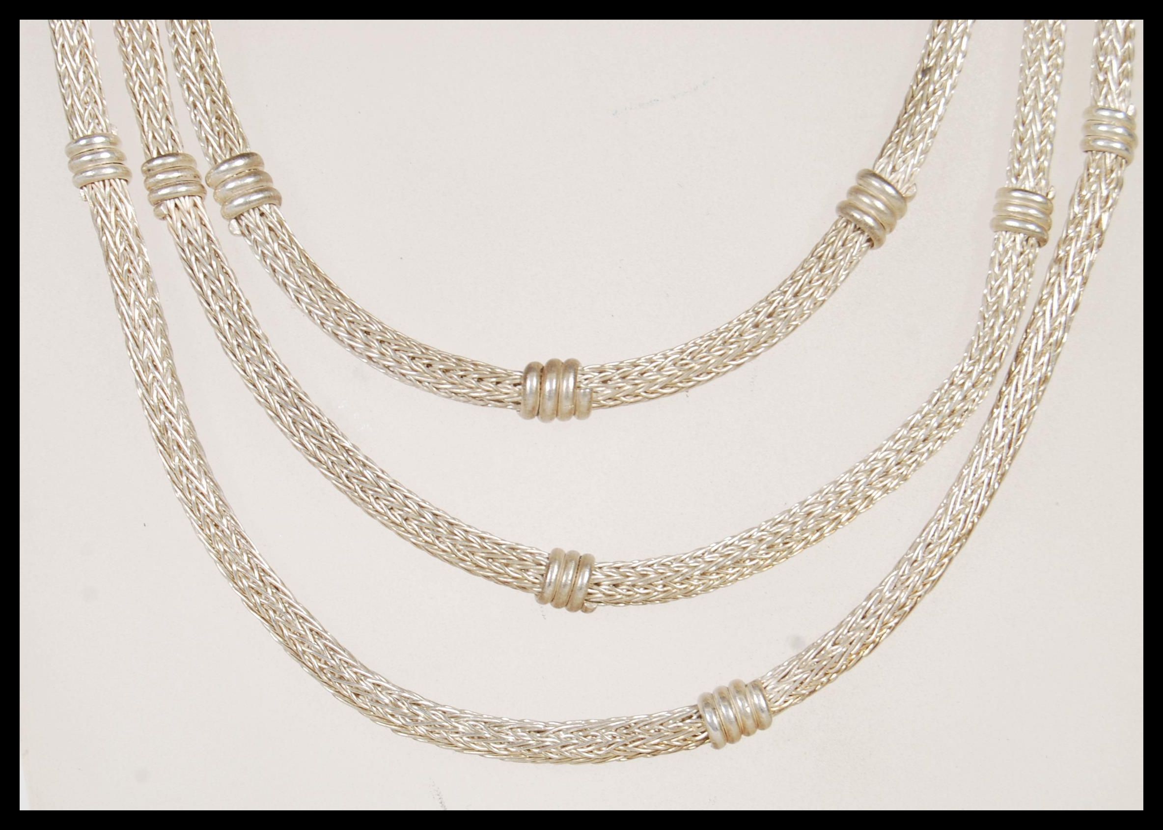 A 20th Century ethnic style silver necklace having three graduating snake chains with engraved - Image 2 of 5