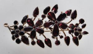 A 19TH CENTURY VICTORIAN FLAT CUT GARNET BROOCH