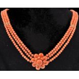 A vintage 14ct gold and coral three strand necklac