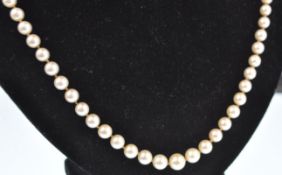 A pearl sapphire and diamond matinee necklace. The