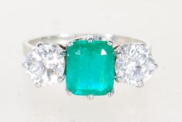 EMERALD AND DIAMOND WHITE GOLD THREE STONE RING.