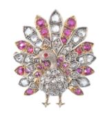 A gold diamond, ruby and red stone figural brooch.