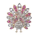 A gold diamond, ruby and red stone figural brooch.