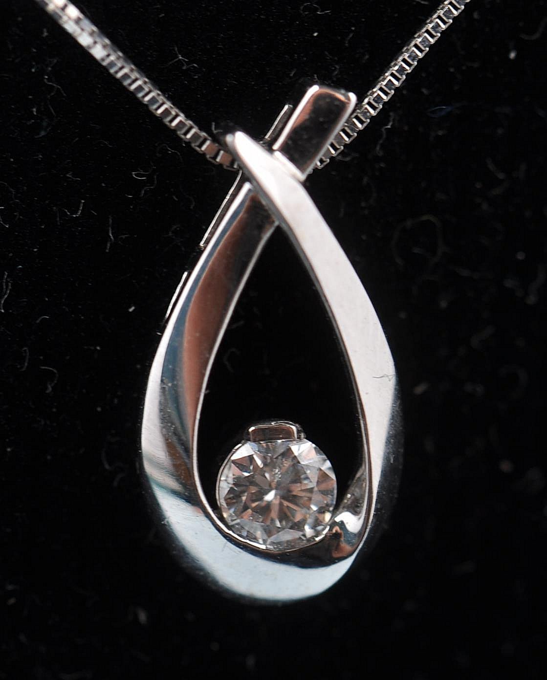 A 10ct white gold and diamond necklace and pendant