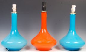 GROUP OF THREE HOLMEGAARD CASED ORANGE GLASS LAMPS.