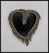A stamped 925 silver heart shaped brooch having on
